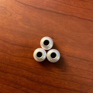 pandora like charms… not real pandora but fit the bracelets. Pearly white